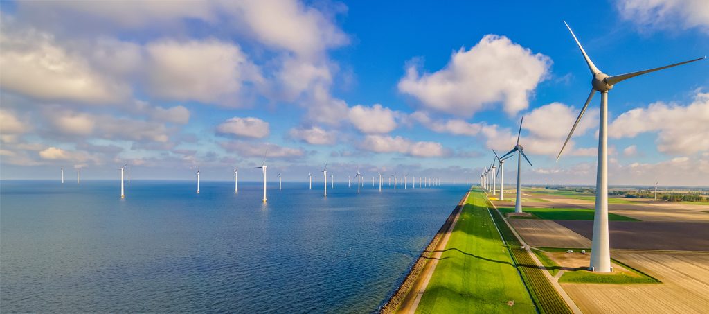 Wind turbines at sea generate green renewable energy in the Netherlands.